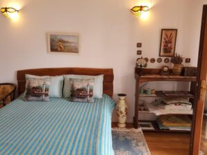 Rustic bedroom with traditional decor, bed and shelves.