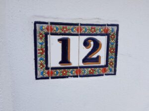 House number 12 on decorative plaques.