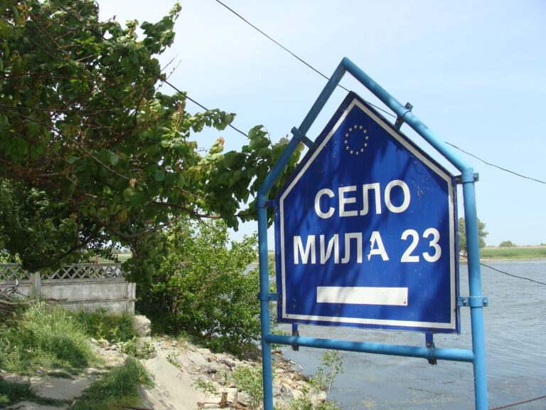 Road sign by the water, Mile 23, Ukraine.