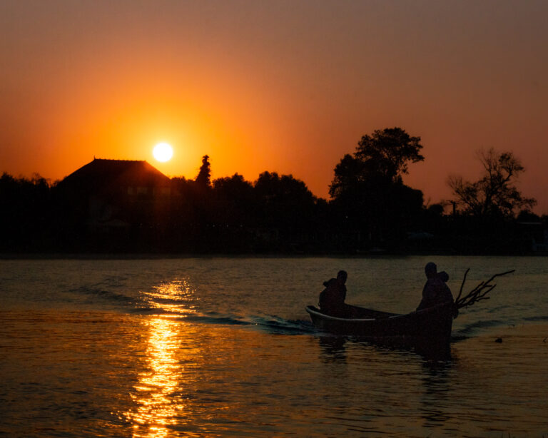 Spectacular sunset over the lake by boat.